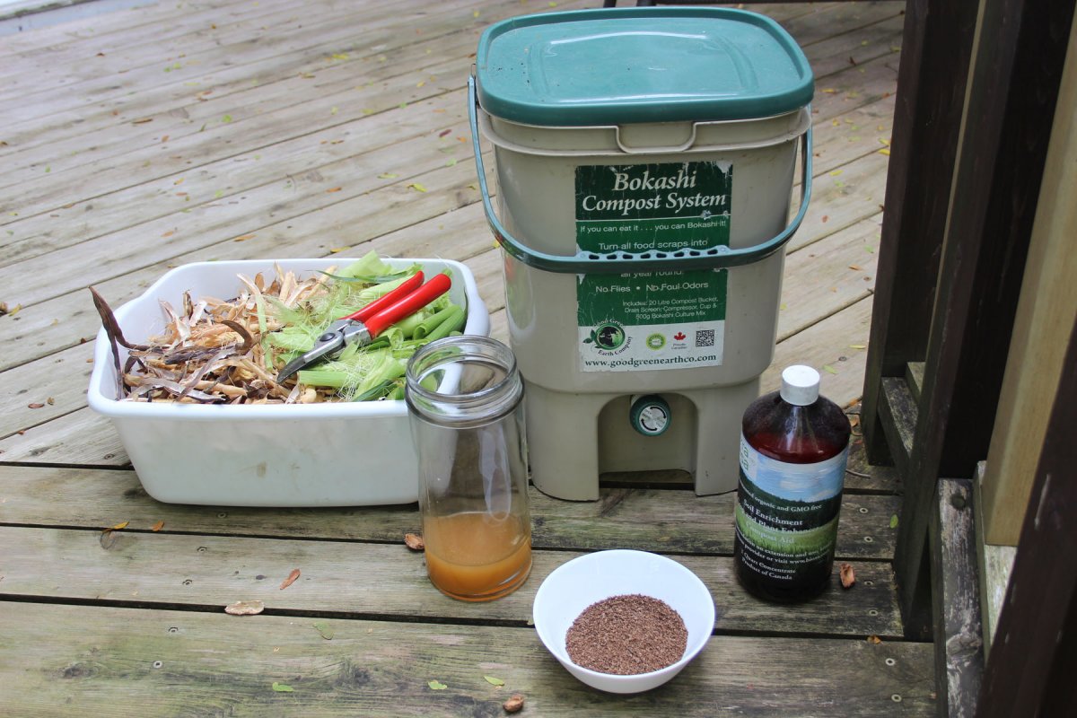 A bokashi pail, some coarse, mostly dry material and bokashi bran
